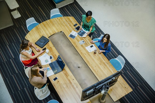 High angle view of businesswomen working in office meeting