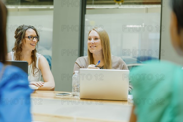 Businesswomen talking in office meeting