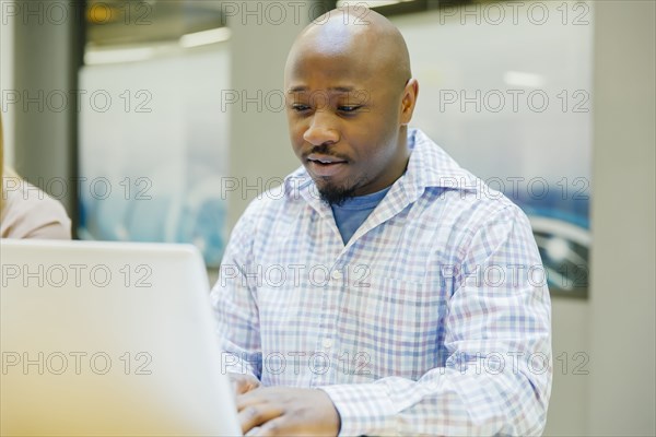 Businessman working on laptop in office