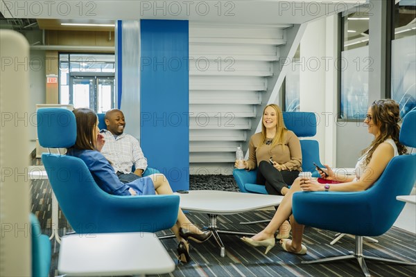 Business people talking in office lobby