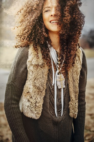 Mixed race woman wearing stylish vest outdoors