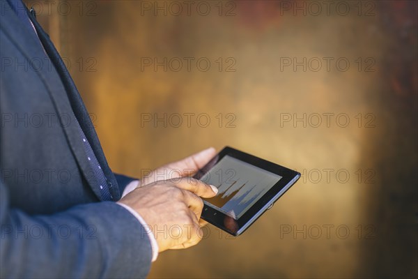 Mixed race businessman using digital tablet