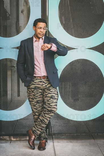 Stylish Mixed race businessman checking his watch