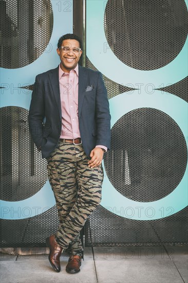 Stylish Mixed race businessman smiling outdoors