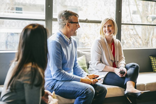 Business people talking in office lobby