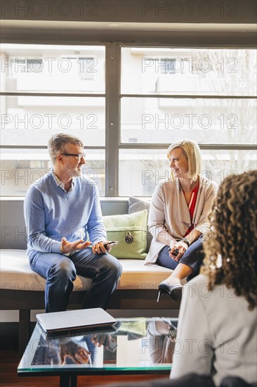 Business people talking in office lobby