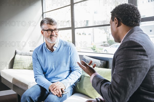 Businessmen talking in office lobby