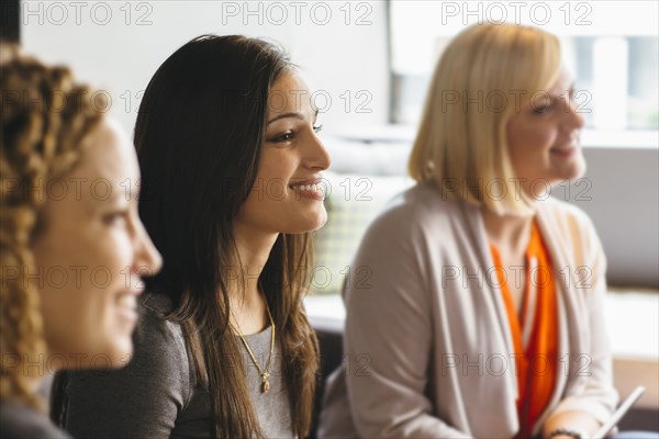 Businesswomen listening in office meeting