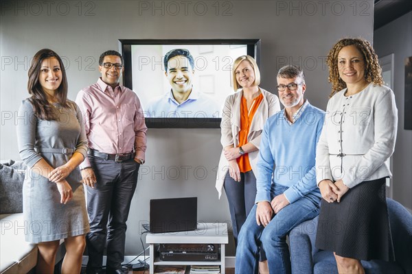 Business people smiling with teleconference in office meeting