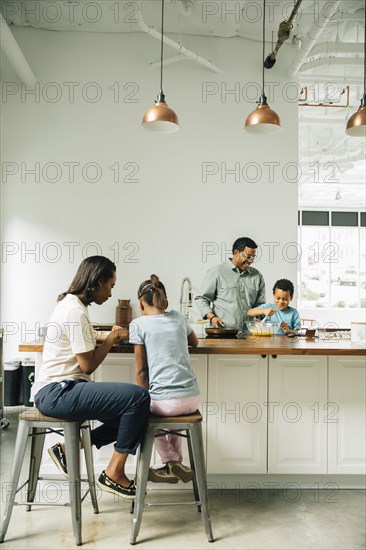 Family cooking in kitchen