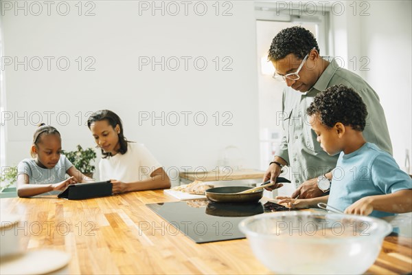 Family cooking in kitchen