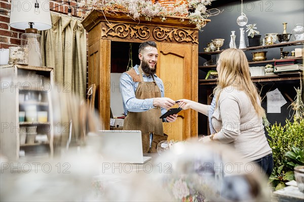 Employee helping customer shopping in store