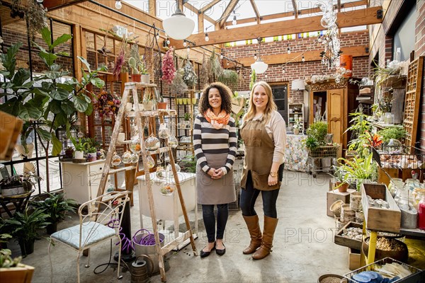 Employee and customer smiling in plant nursery