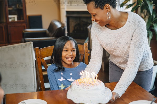 Black mother and daughter celebrating birthday