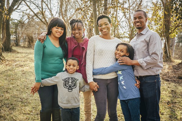 Black family smiling outdoors