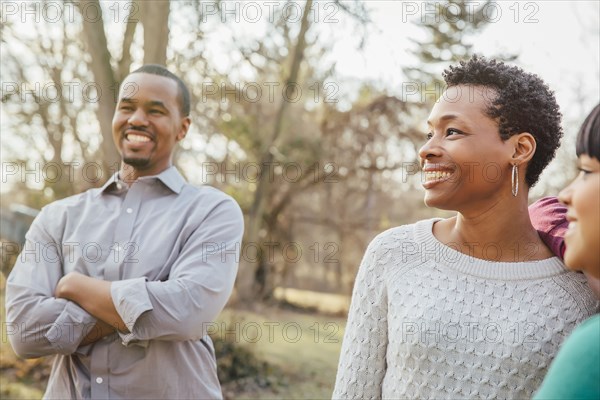 Black family smiling outdoors