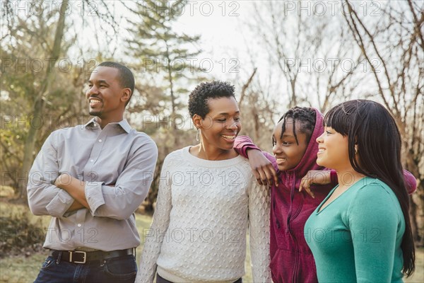 Black family smiling outdoors