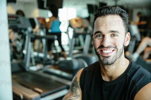 Man using exercise machine in gymnasium