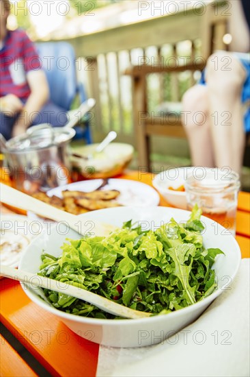 Close up of bowl of salad on lunch table
