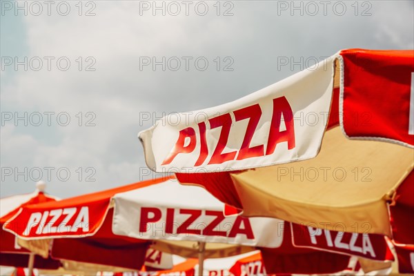 Low angle view of pizza on umbrellas outdoors