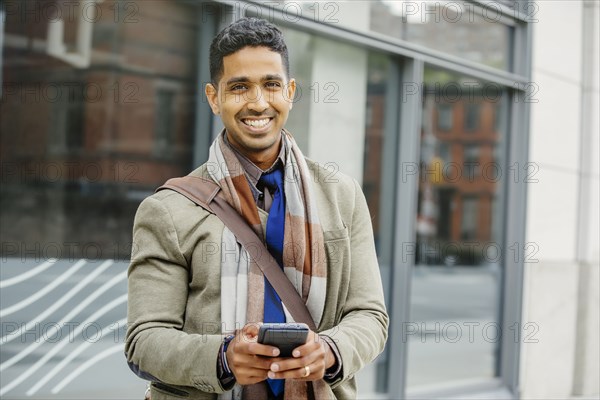 Indian man using cell phone in city