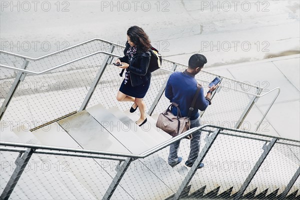 People using cell phones on city steps