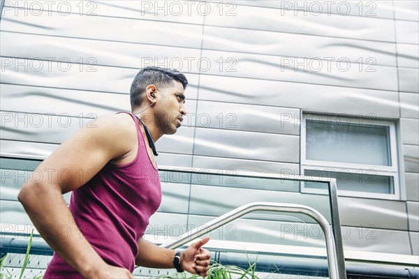 Indian man jogging on city steps