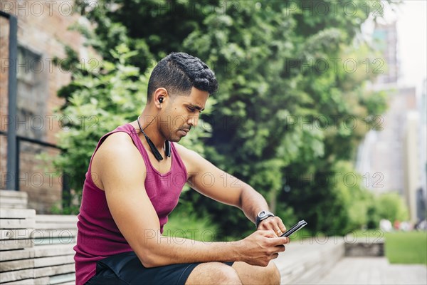 Indian athlete timing himself in city