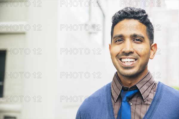 Indian man smiling outdoors