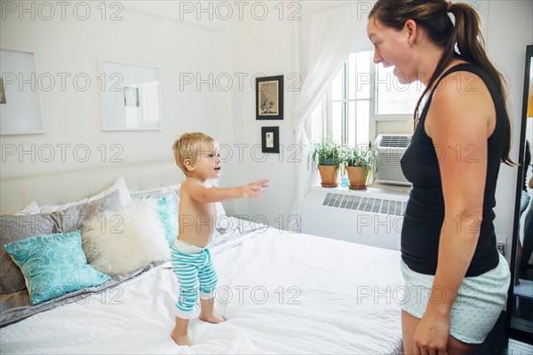 Mother and son talking in bedroom