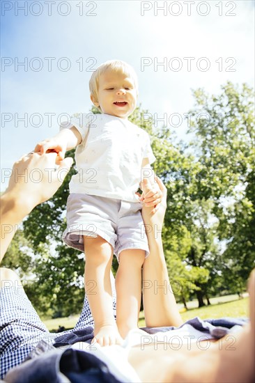 Father and son playing in grass in park