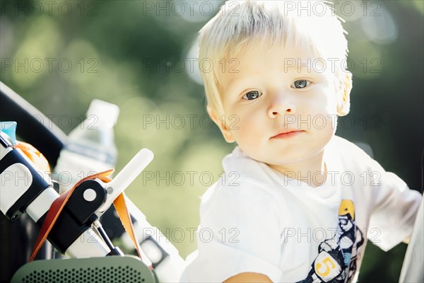 Close up of mixed race boy sitting in stroller