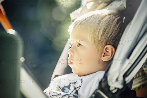 Close up of mixed race boy sitting in stroller