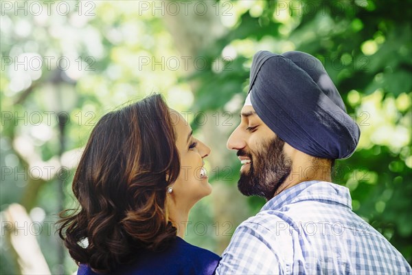 Close up of smiling Indian couple hugging