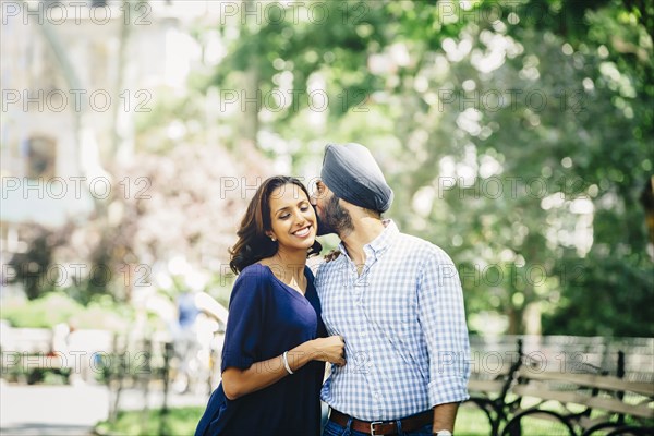 Indian couple kissing in urban park