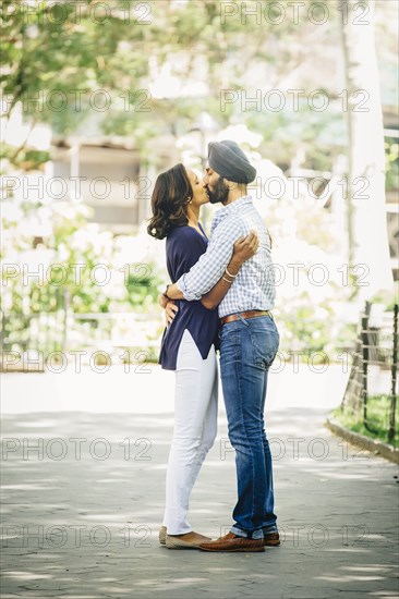 Indian couple kissing in urban park