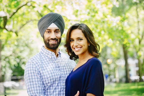 Indian couple hugging in urban park