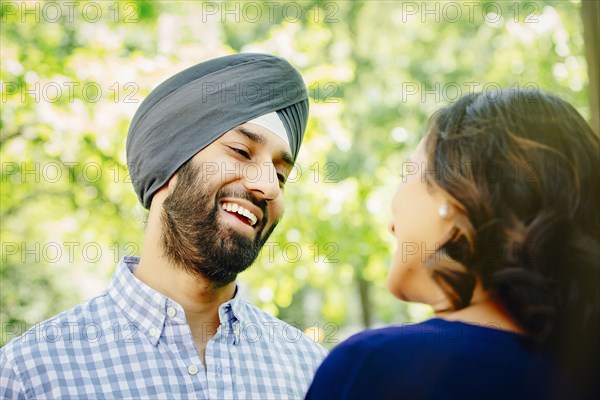 Indian couple talking in urban park