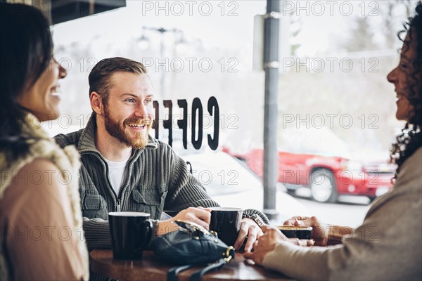 Friends drinking coffee in cafe