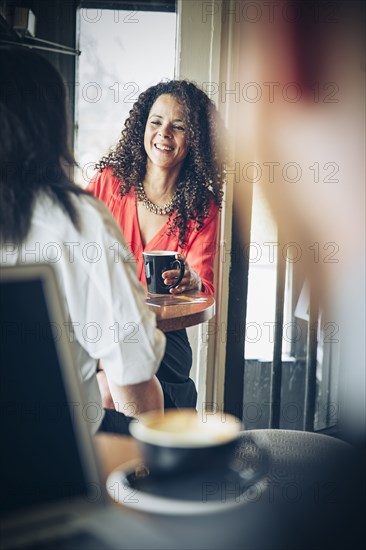 Businesswomen drinking coffee in cafe