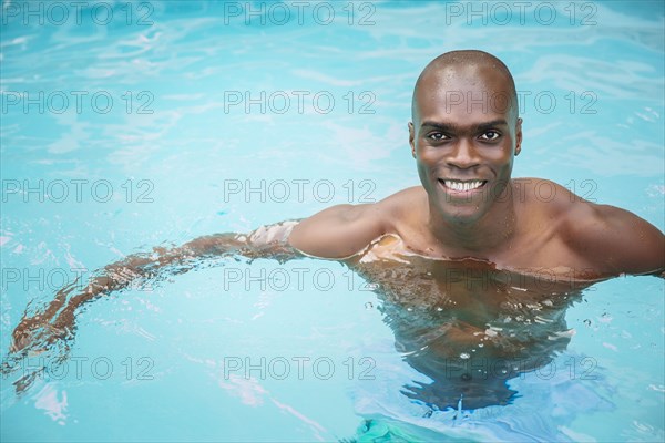 Black man swimming in pool