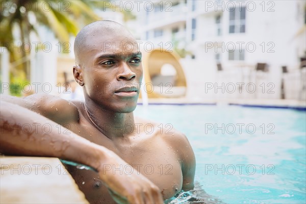 Black man standing in swimming pool