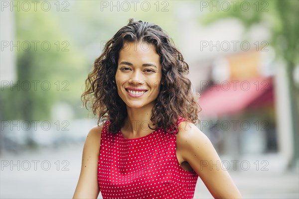 Mixed race woman smiling in city