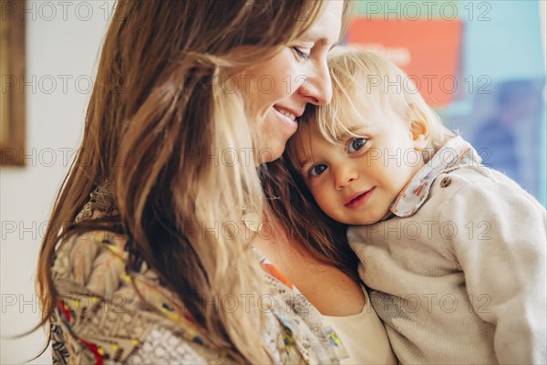 Caucasian mother holding baby son