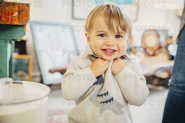 Caucasian baby boy smiling in living room