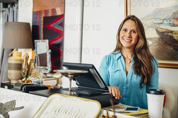 Caucasian clerk standing at register in store