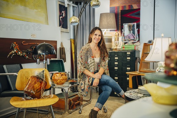 Caucasian entrepreneur sitting in store