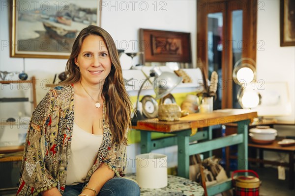 Caucasian entrepreneur sitting in store