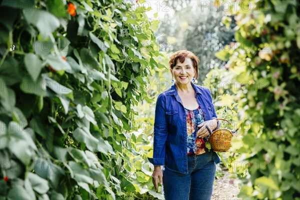 Caucasian woman picking vegetables in garden