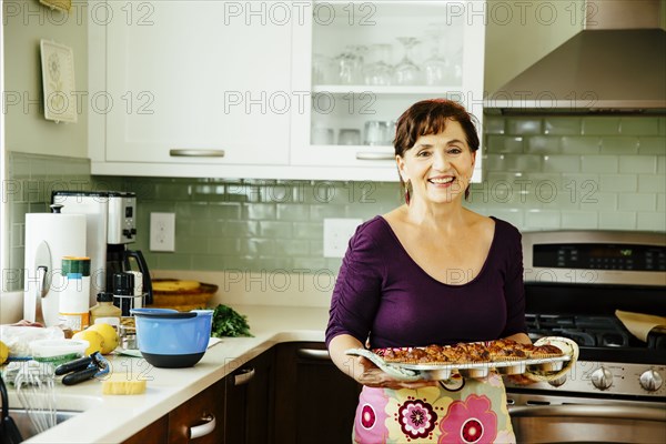 Caucasian woman cooking in kitchen